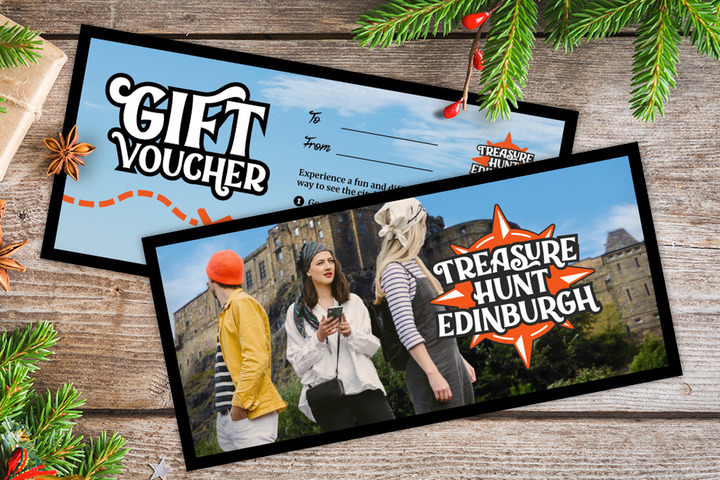 A gift voucher for Treasure Hunt Edinburgh on a table covered with Christmas decorations