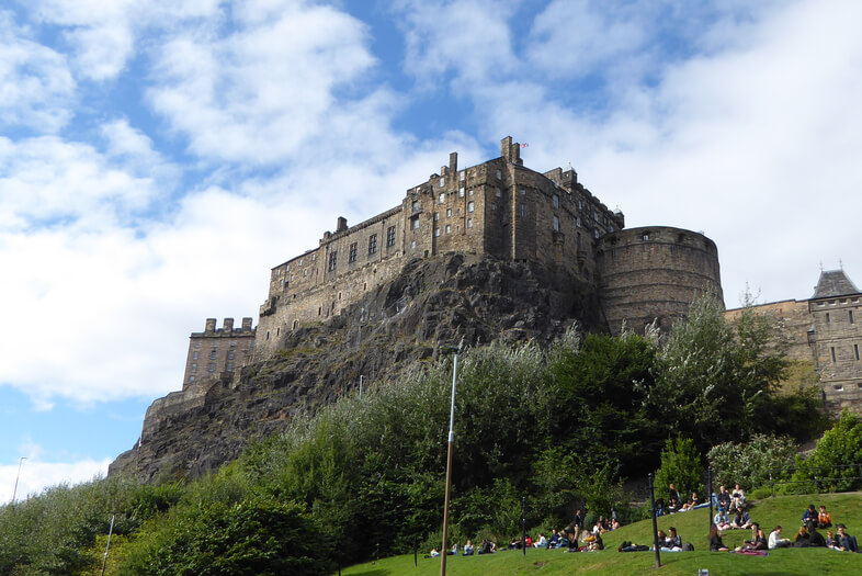 Edinburgh Castle atop a steep craggy hill, taken from below